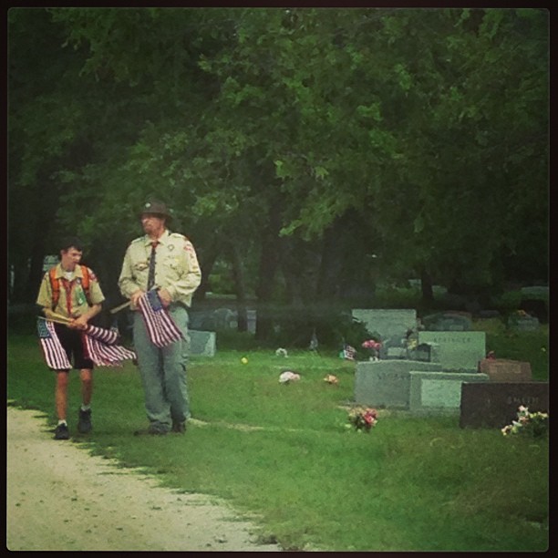 Boy Scout troop placing flags on soldier's graves for Memorial Day in Texas